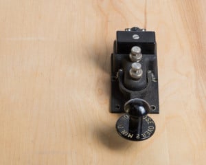 Antique telegraph key on a desk - used Morse_code.