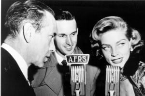 Attribution: Armed Forces Radio Services broadcaster Jack Brown interviews Humphrey Bogart and Lauren Bacall for broadcast to troops overseas during World War II.  Source: AFRTS.  http://commons.wikimedia.org/wiki/File:Bogart_Bacall_AFRS.jpg