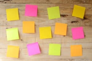 My blog post on Sticky Notes Letter Writing - image of empty colorful sticky notes on wooden bulletin board, ready for message