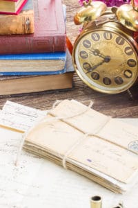 Antique clock with pile of mail